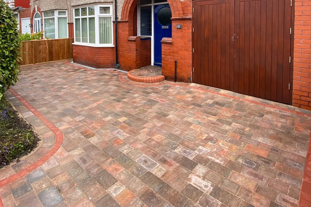 Paved and edged driveway in front of a suburban home.