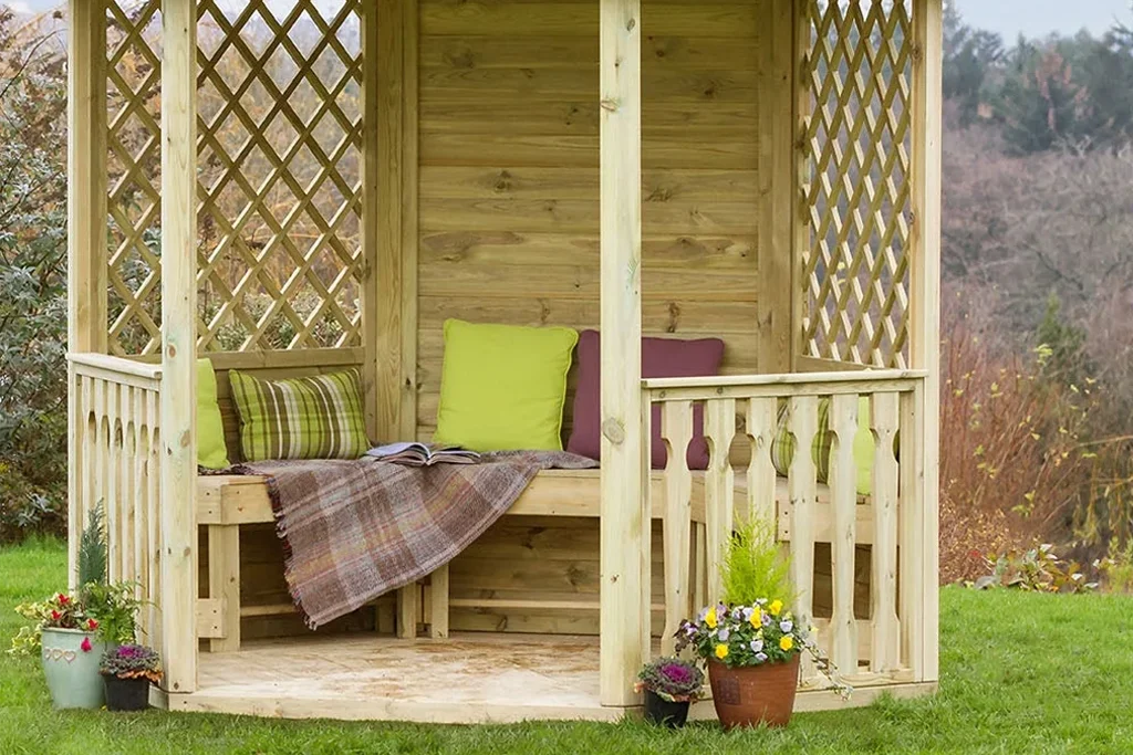 Wooden gazebo with scatter cushions and blanket